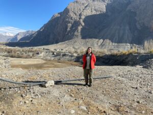 Sasha Oliveira standing on rocky ground with a mountain in the background